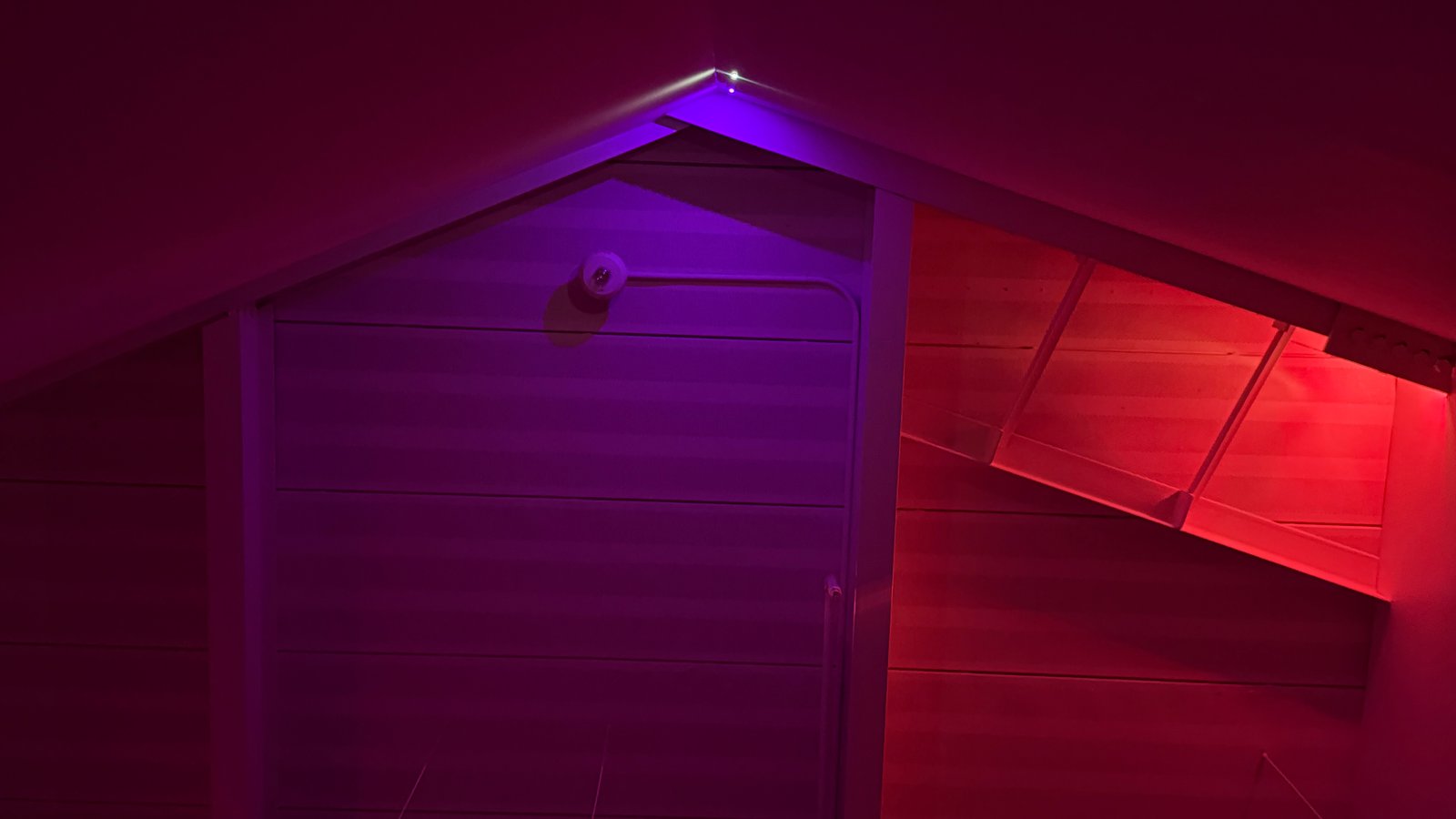 Violet and red laser light traces the peaked architecture of Traces of Living Light.